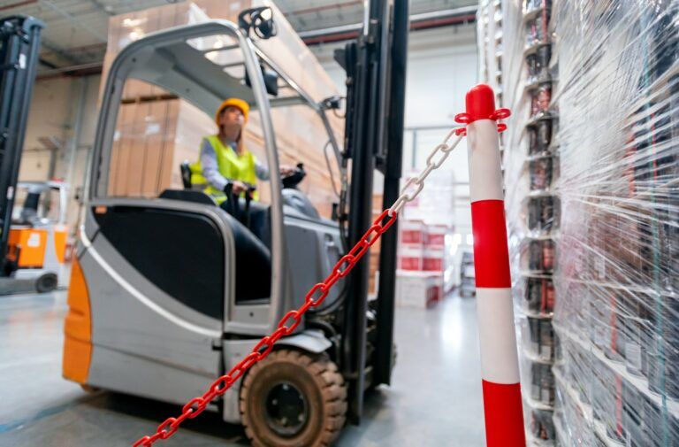 Safety at work with forklift in warehouse
